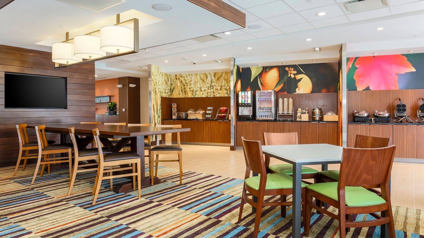 Modern retro dinning room view of tables and chairs with the complimentary breakfast counter